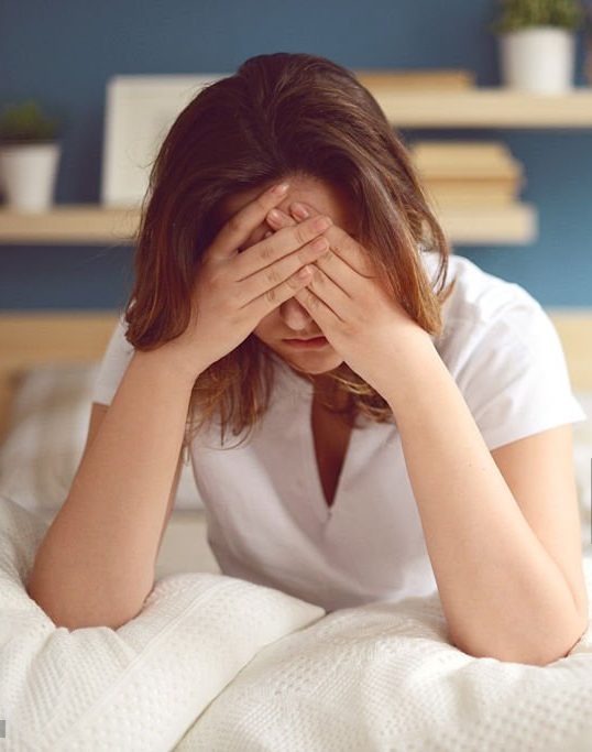 Unhappy girl in a bedroom